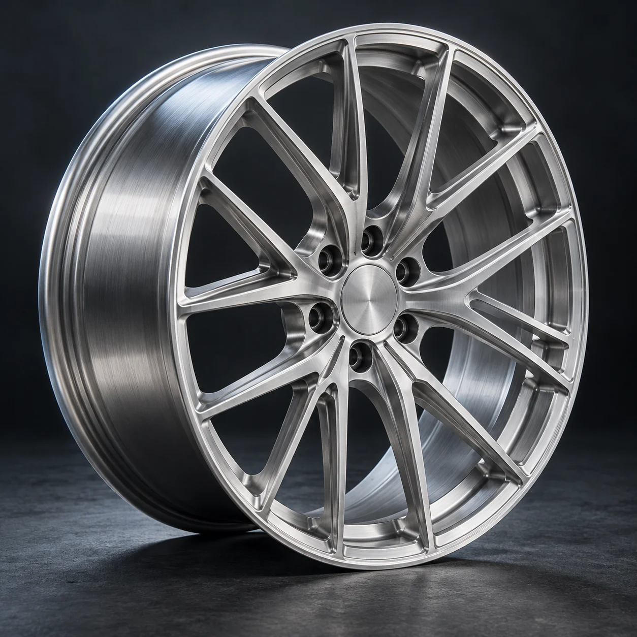 Brushed silver multi-spoke forged aluminum wheel at a three-quarter studio angle