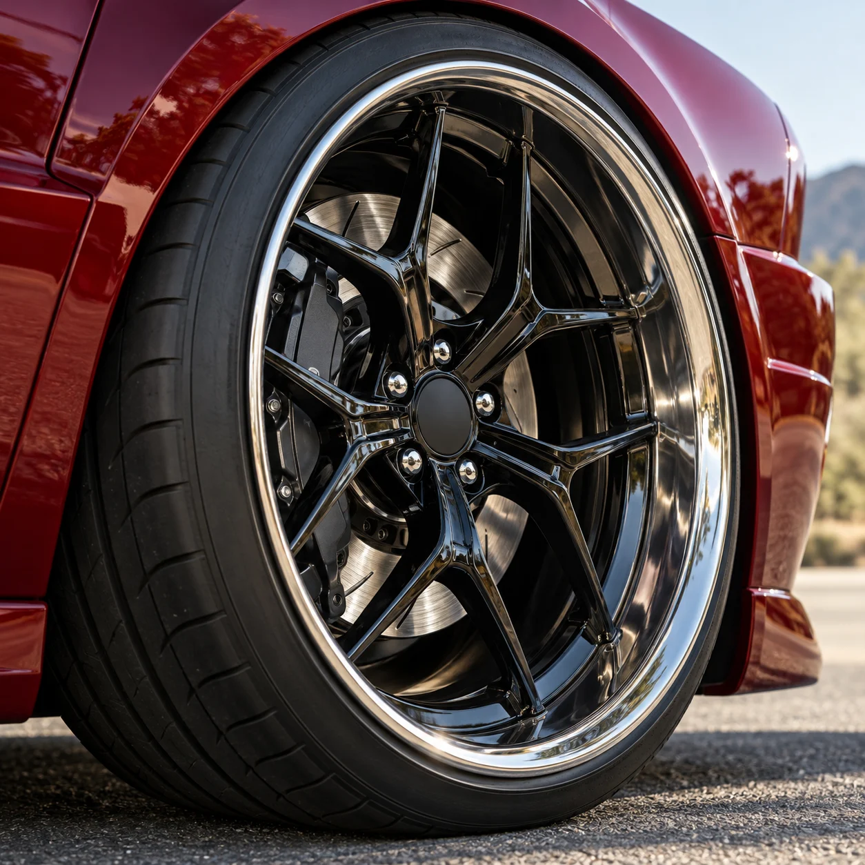 Illustrative close-up of a gloss black deep-concave forged wheel with polished wide lip and big brake caliper