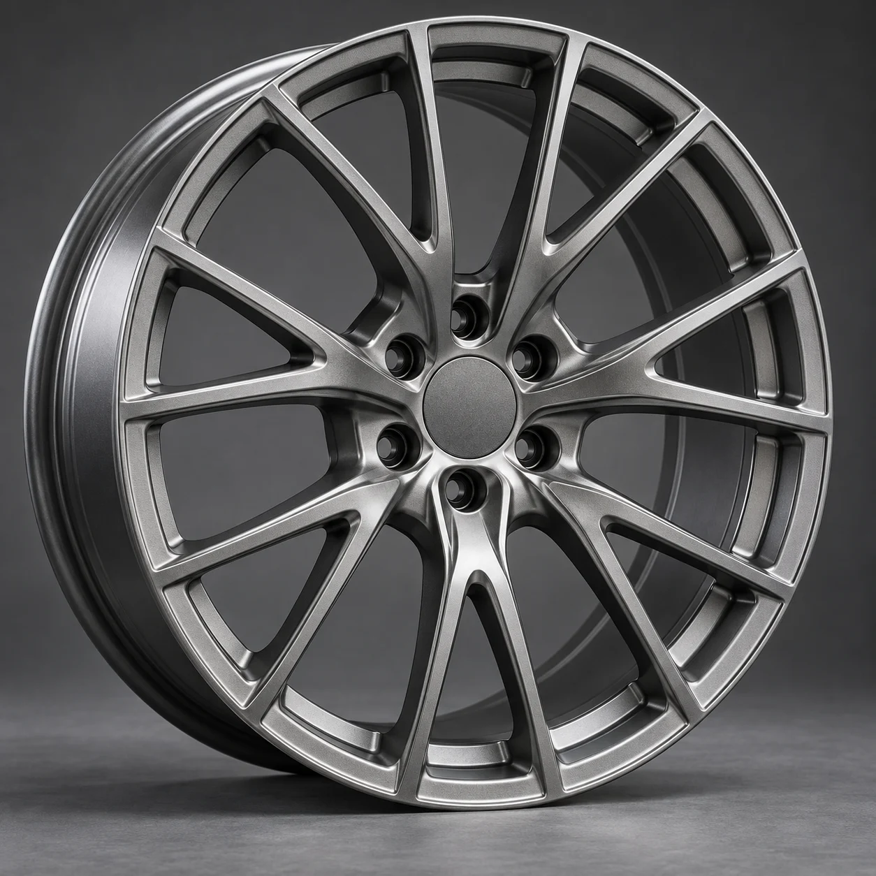Illustrative satin gunmetal multi-spoke forged monoblock wheel with shallow dish, studio shot